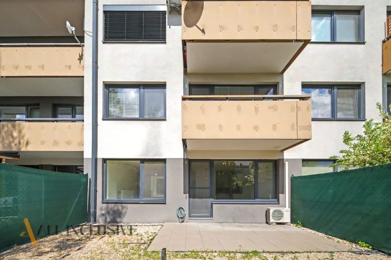 A building with balconies and a green barrier near a 2-room apartment in Dunajská Lužná.