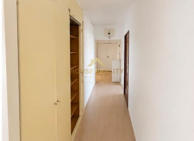 A hallway with storage space and a wooden decor floor in a 3-room apartment.