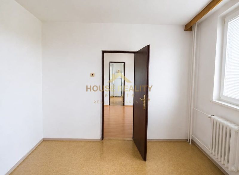 A white interior in a 3-room apartment with doors and a window.