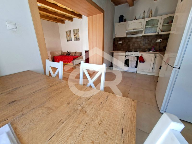 A kitchen and dining table with a wooden decor in a family house.