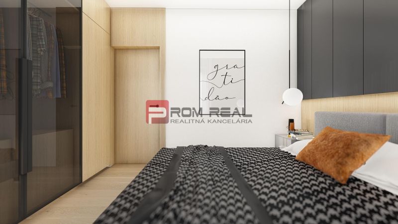 A bedroom in a 2-room apartment with a wood-patterned floor, a wardrobe, and wall art.