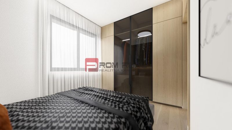 Bedroom with a large wardrobe, bed, and wooden decor flooring in a 2-room apartment.