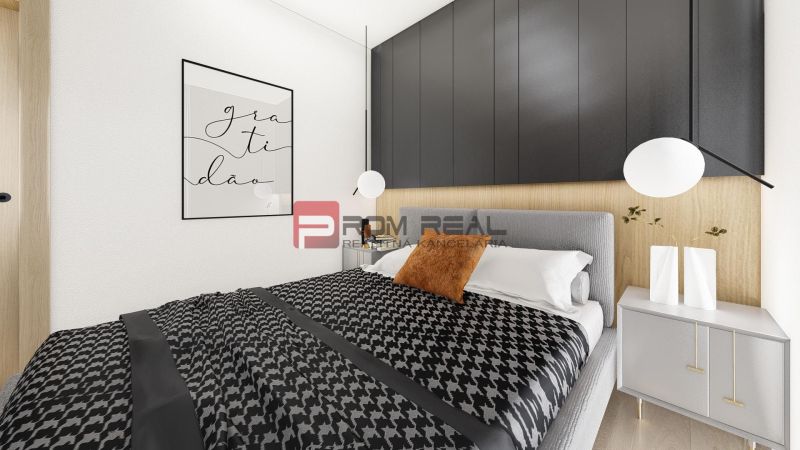 A bedroom with black cabinets, a gray bed, and decorative vases in a two-room apartment.