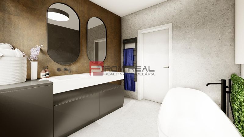 A bathroom in a 4-room apartment with two oval mirrors and a white bathtub.