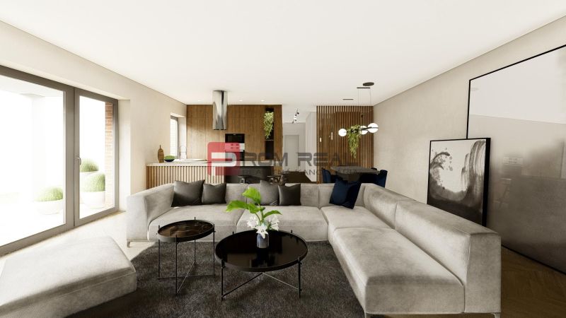 Living room in a 4-room apartment with a large sofa and a wooden decor floor.