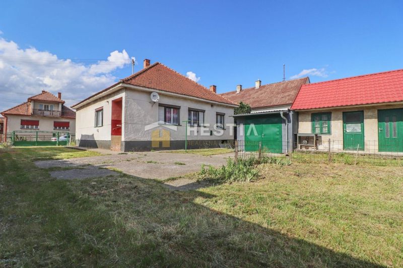 A family house in Borský Mikuláš with a garden and a garage on a grassy plot.