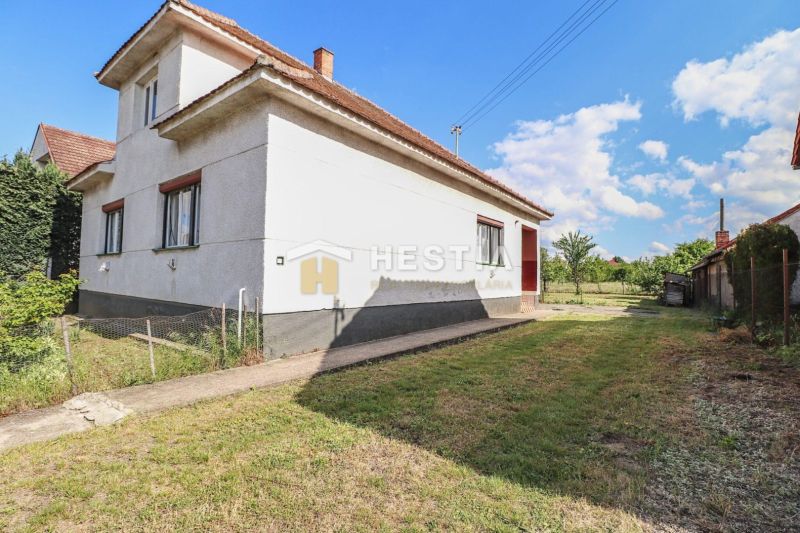 A family house in Borský Mikuláš with a grassy plot and a blue sky.