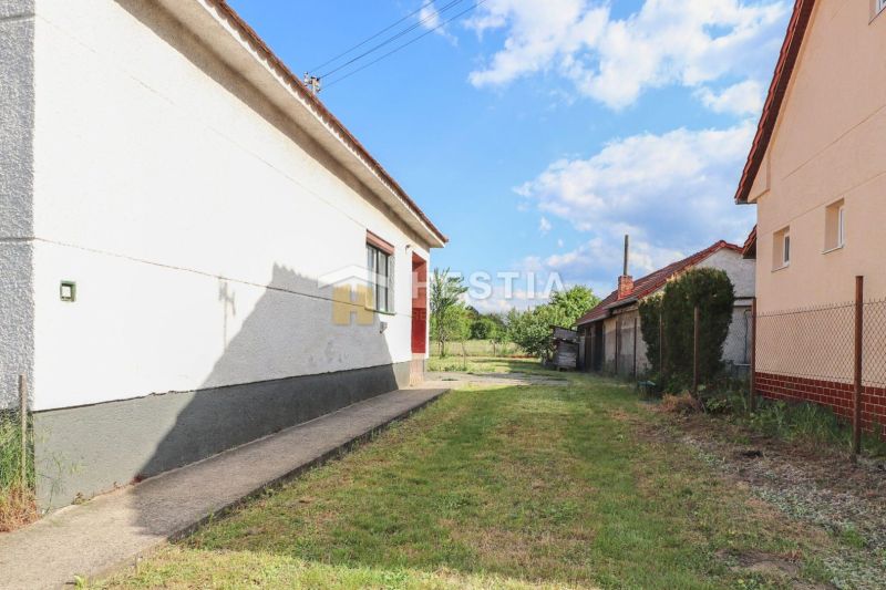 A view of the backyard of a family house in Borský Mikuláš with a grassy area.