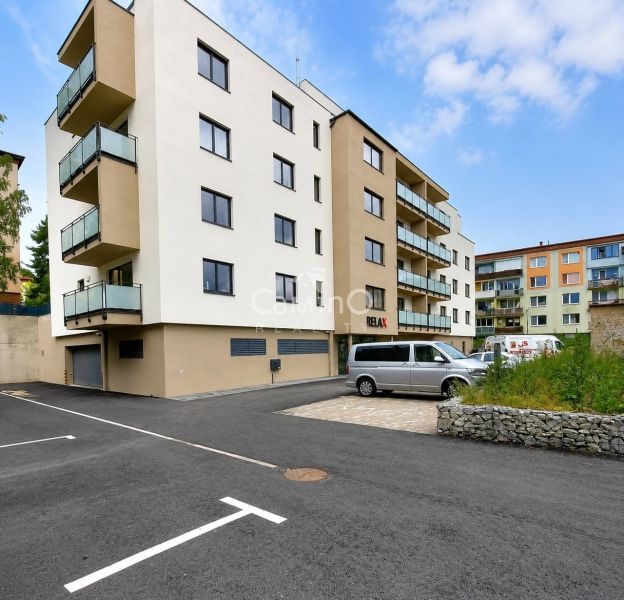 An apartment building on Letná Street in Stará Ľubovňa with parking spaces in front of the building.