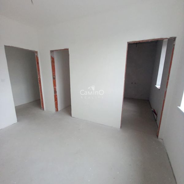 Interior of a 2-room apartment with unfinished walls and empty rooms for renovation.