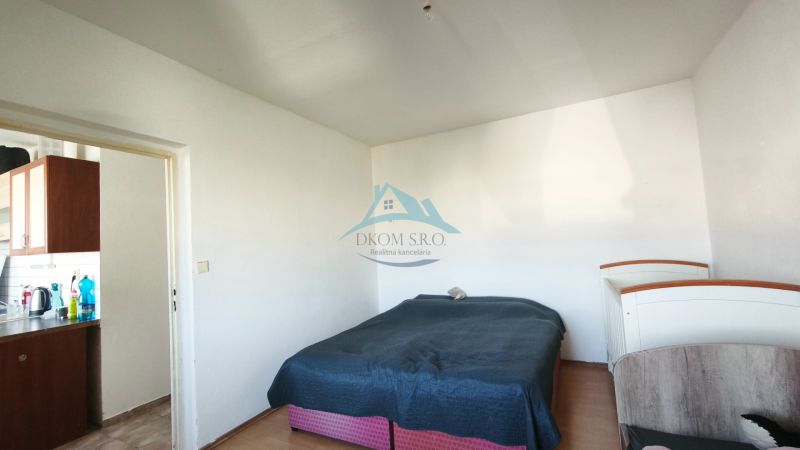 Bedroom in a 2-room apartment with a bed and IKEA furniture. Floor with wood decor.