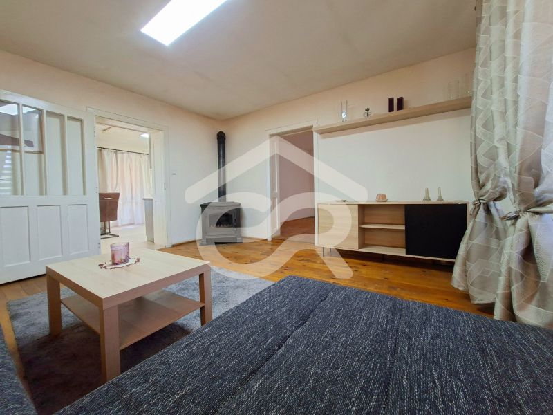 Living room in a family house with a wood-burning stove and a floor with a wooden decor.