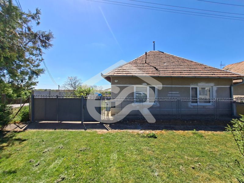 A family house on Jasová Street in Jasová with a grassy garden and fencing.