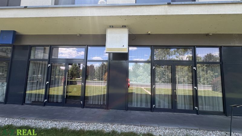 Commercial premises on Nové záhrady I, Bratislava - Ružinov, with a glass entrance and outdoor greenery.