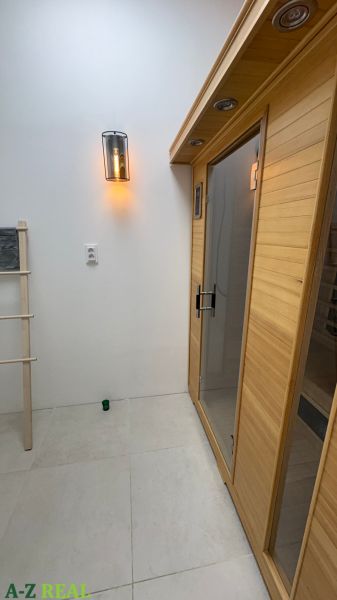 Interior with a wooden sauna and light, commercial spaces.
