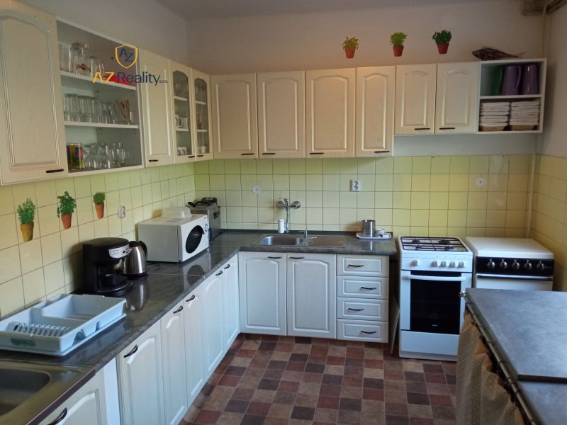 Hotel and guesthouse kitchen with white cabinets and equipment.