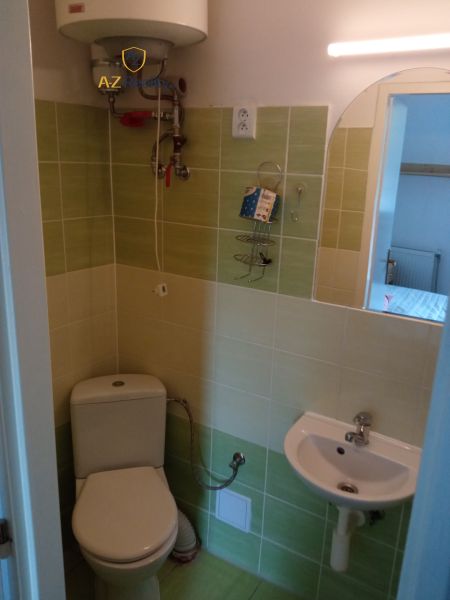Bathroom with toilet, sink, and boiler in hotels and guesthouses.