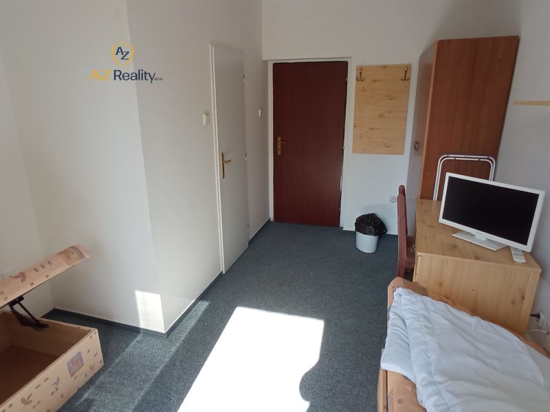 A simple room with a bed, a table, and a television in hotels and guesthouses.