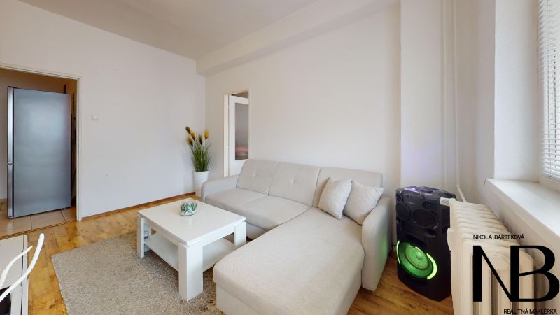 Bright 1-bedroom apartment on K výstavisku Street, with a comfortable sofa and modern amenities.