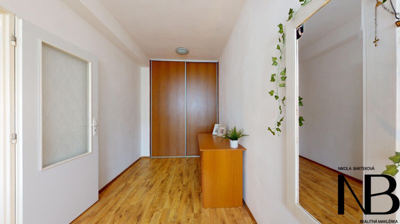 In the 2-room apartment on K výstavisku street, there are wooden floors, wardrobes, and a mirror.
