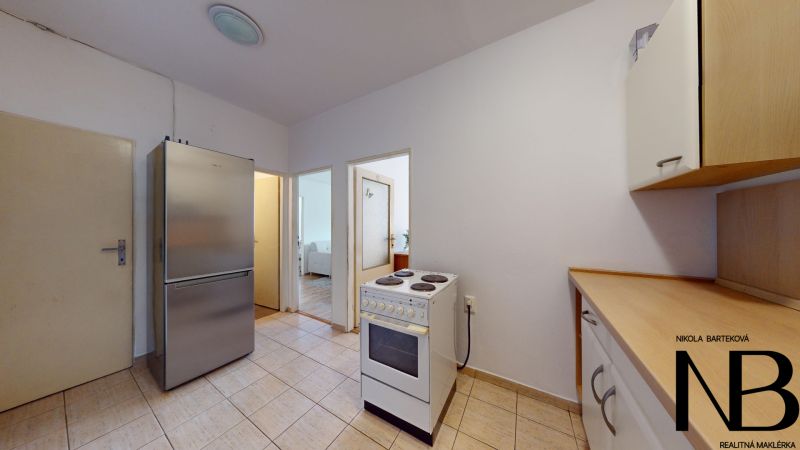 The kitchen of the 2-room apartment on K výstavisku street has white kitchen cabinets.
