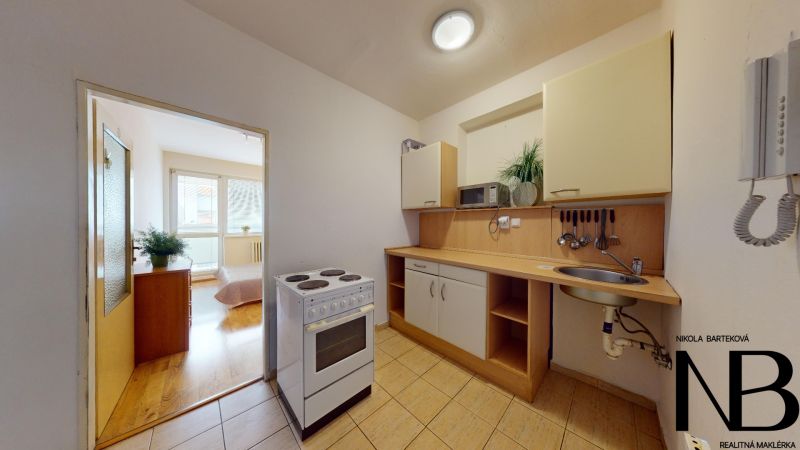 2-room apartment on K výstavisku street with a simple kitchen and wooden floors.
