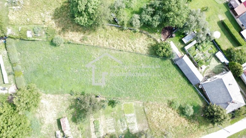 Aerial view of residential plots in Vlachovo with grassy area and garden.