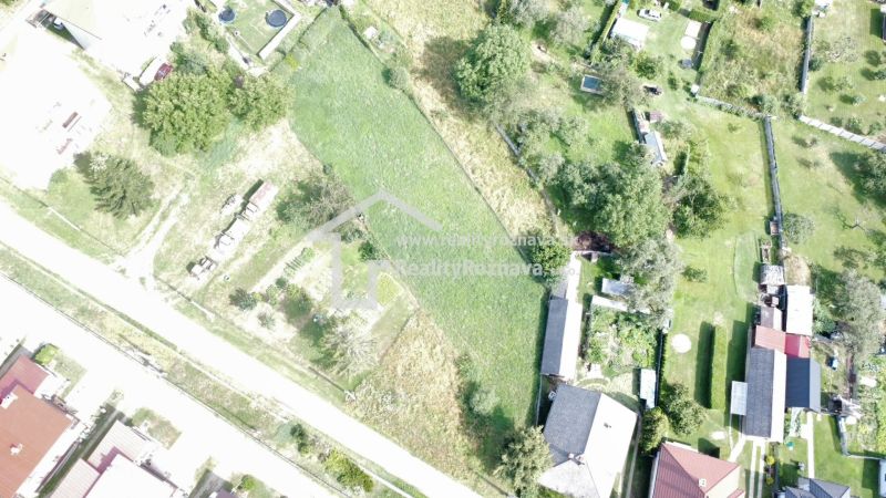 Aerial view of residential plots in Vlachovo with greenery and gardens.