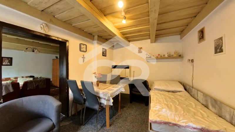 A traditional interior in a family house with simple furniture and wooden decorations.