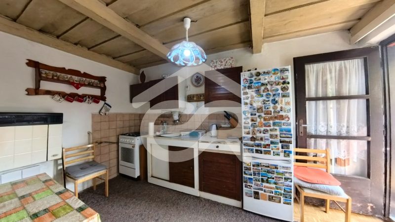 Rustic kitchen in a family house with wooden decor and nostalgic decorations.