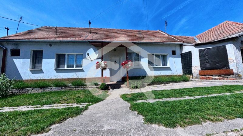 A family house on Kapitána Nálepku Square in Vráble surrounded by a well-maintained lawn.