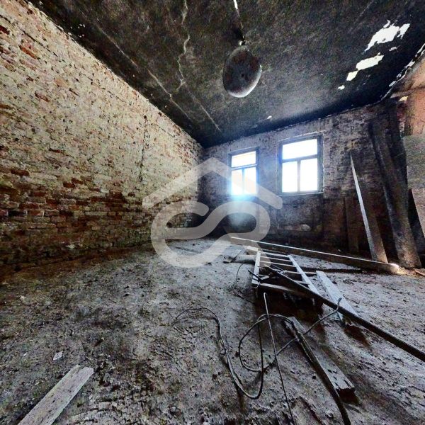 A shabby room with exposed bricks and an unfolded ladder, Family house.