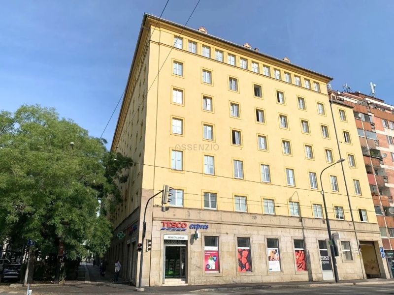 The yellow building on Odborárske Square in Bratislava - Staré Mesto with shops on the ground floor.