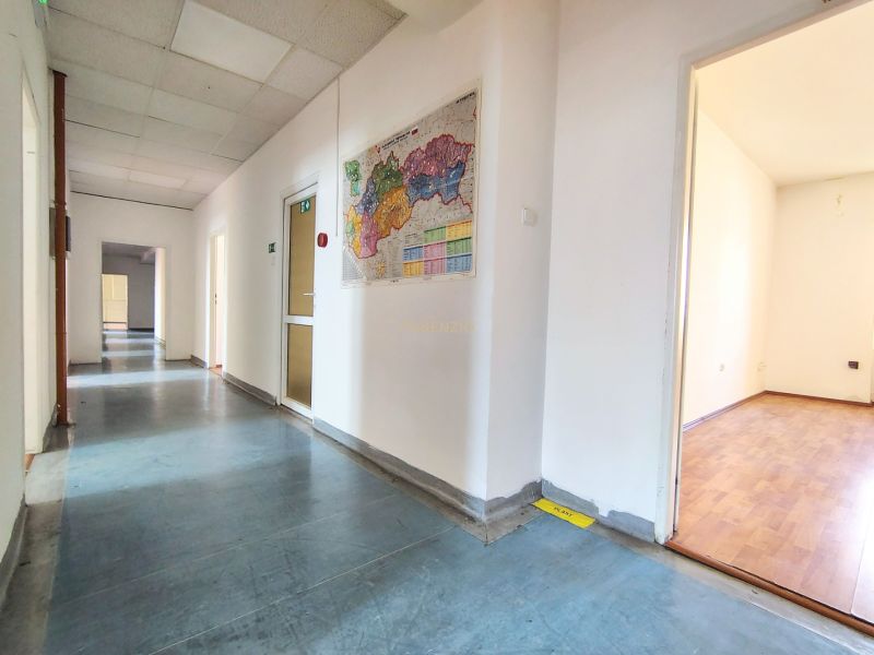 A hallway in offices with a displayed map, wooden decor flooring at Odborárske námestie.