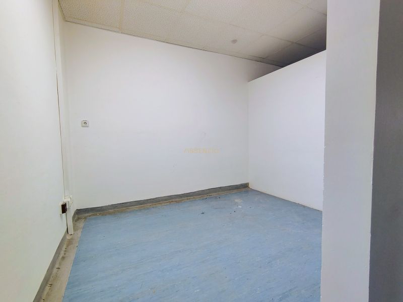 Offices with white walls and blue flooring.
