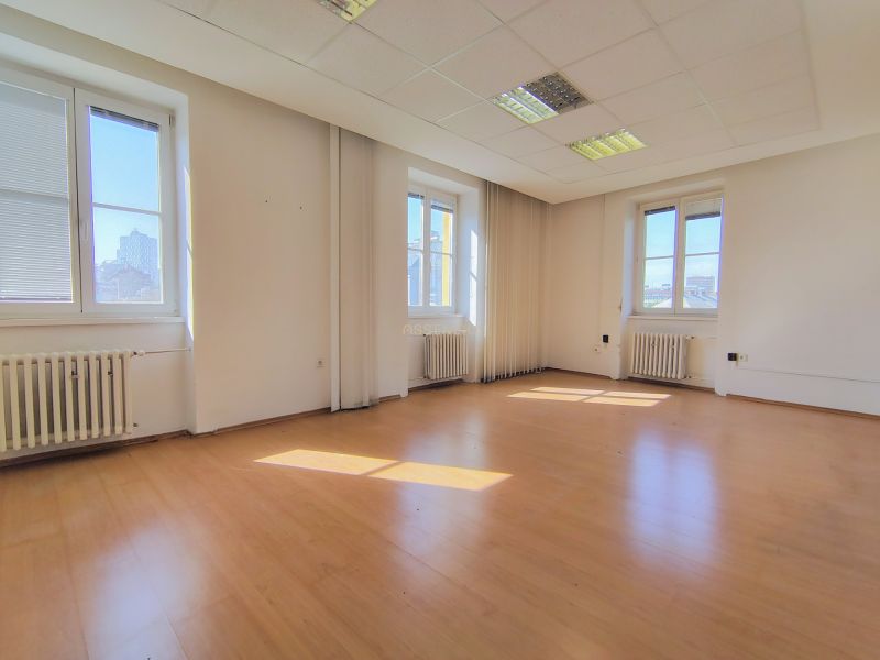 Empty office with wood-patterned flooring and large windows, Bratislava - Staré Mesto.