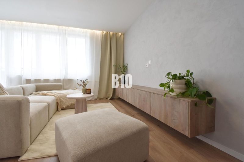 Comfortable living room with a light sofa, wooden decor flooring, 4-room apartment.