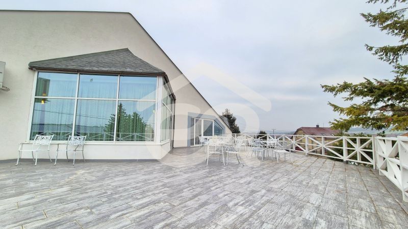 Outdoor terrace in hotels and guesthouses in Veľký Lapáš with white furniture.
