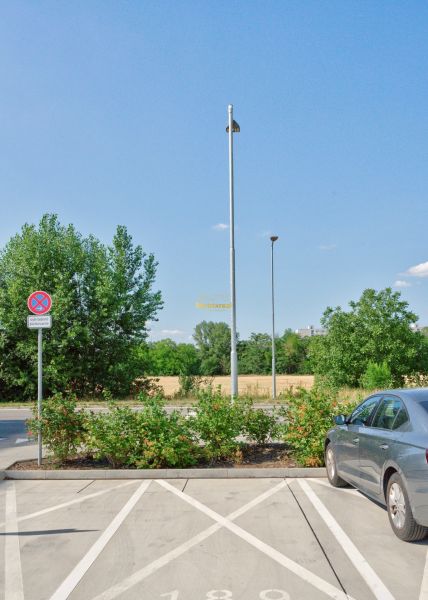Parking lot on Labutia Street in Bratislava - Petržalka, with a reserved parking sign.