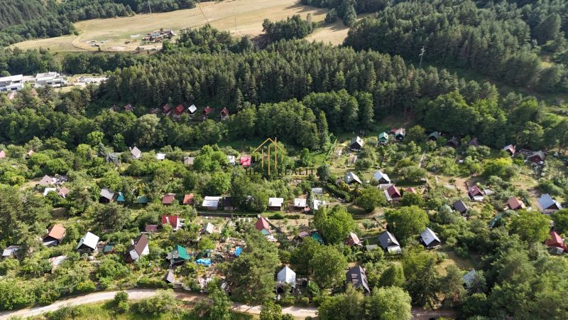 Aerial view of a cottage area surrounded by forests near Banská Bystrica.