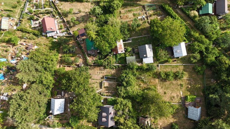 A cottage in the Banská Bystrica area, surrounded by gardens and trees, offers peaceful nature.