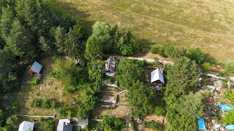 A cottage in Banská Bystrica surrounded by trees and greenery in a natural setting.