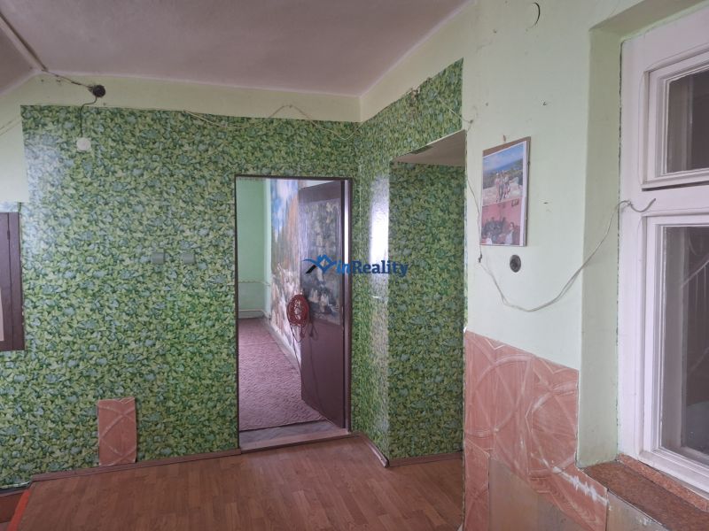 Interior of a family house with floral wallpaper and wooden decor flooring.