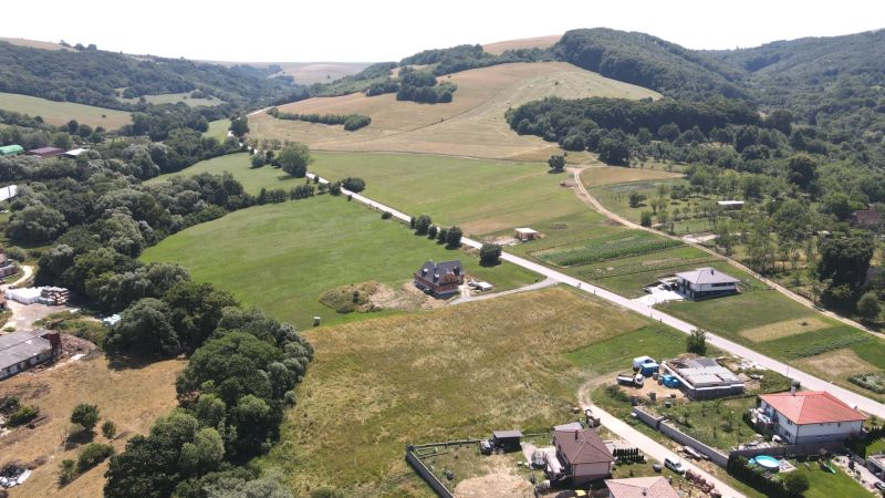 Land with residential plots near Laski Street in Vrbovce, green fields and houses.