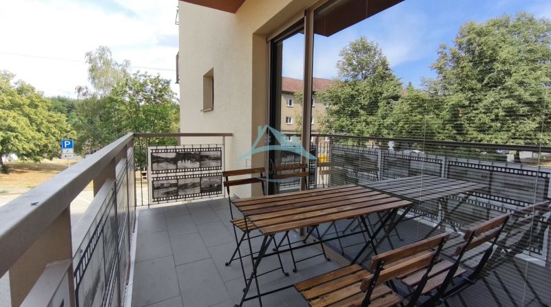 A balcony with wooden seating in a 2-room apartment on Okružná Street, Veľký Krtíš.