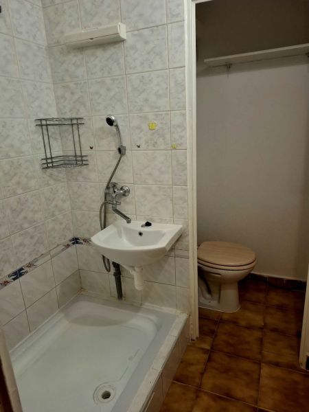 Bathroom with a shower and toilet in a studio apartment.