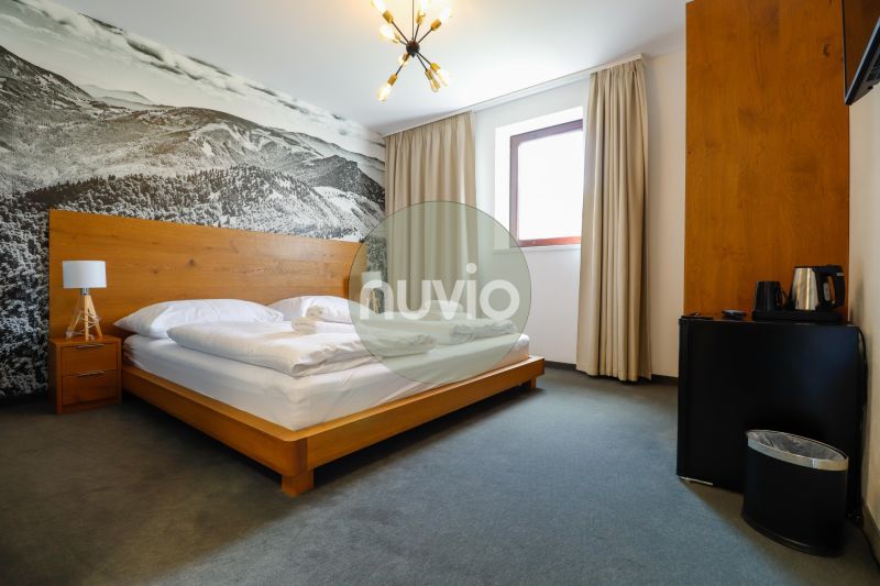 Double room in a Holiday Apartment with a decorative wall and minimalist furnishings.