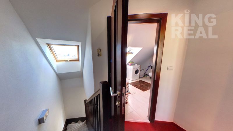 Hallway with staircase and view of the bathroom in a 2-room apartment.