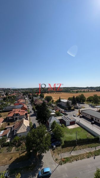 A view of the street and the surrounding landscape with fields in Levice.