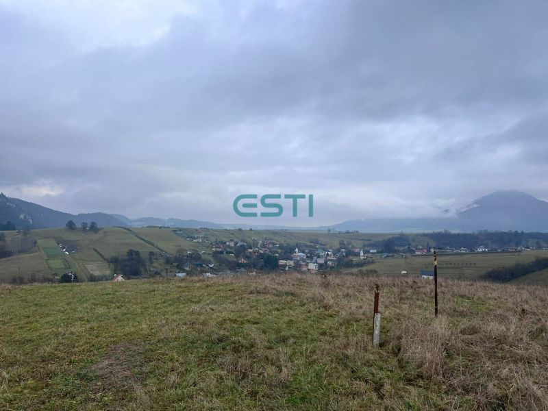 The landscape of agricultural and forest lands near Stránske with a rising mountain panorama.